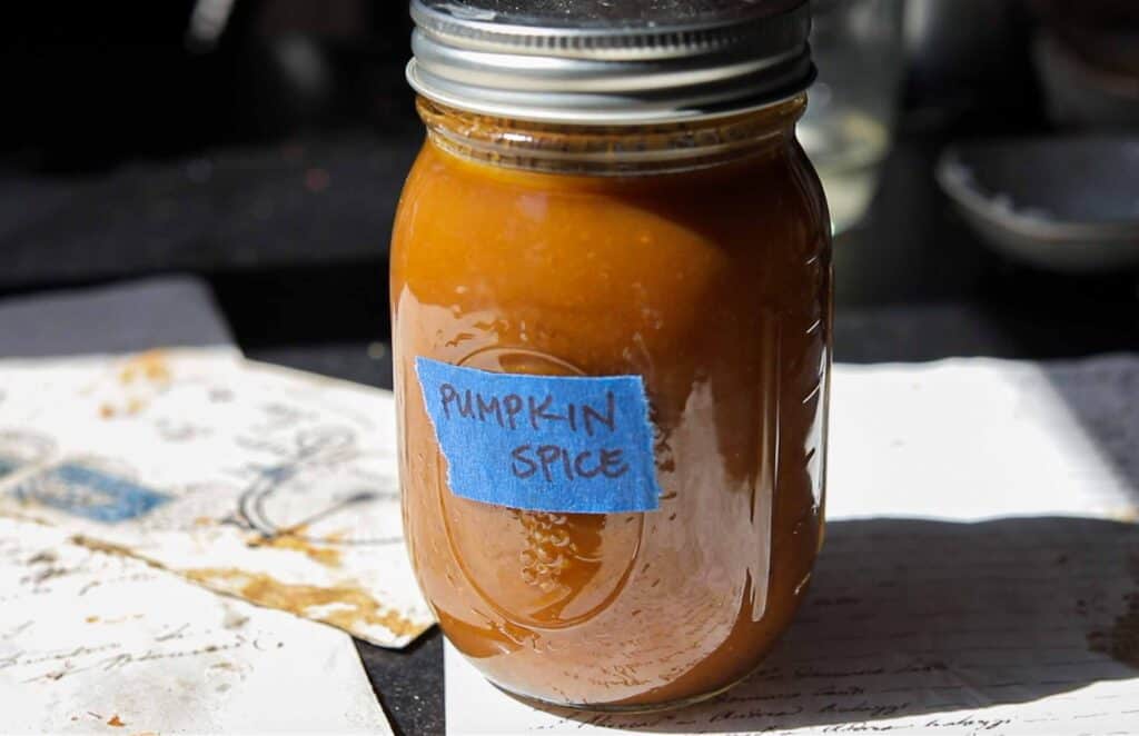 Easy Vegan Pumpkin Spice Syrup (Starbucks Copycat!). 1 hero image of mason jar of vegan pumpkin spice syrup