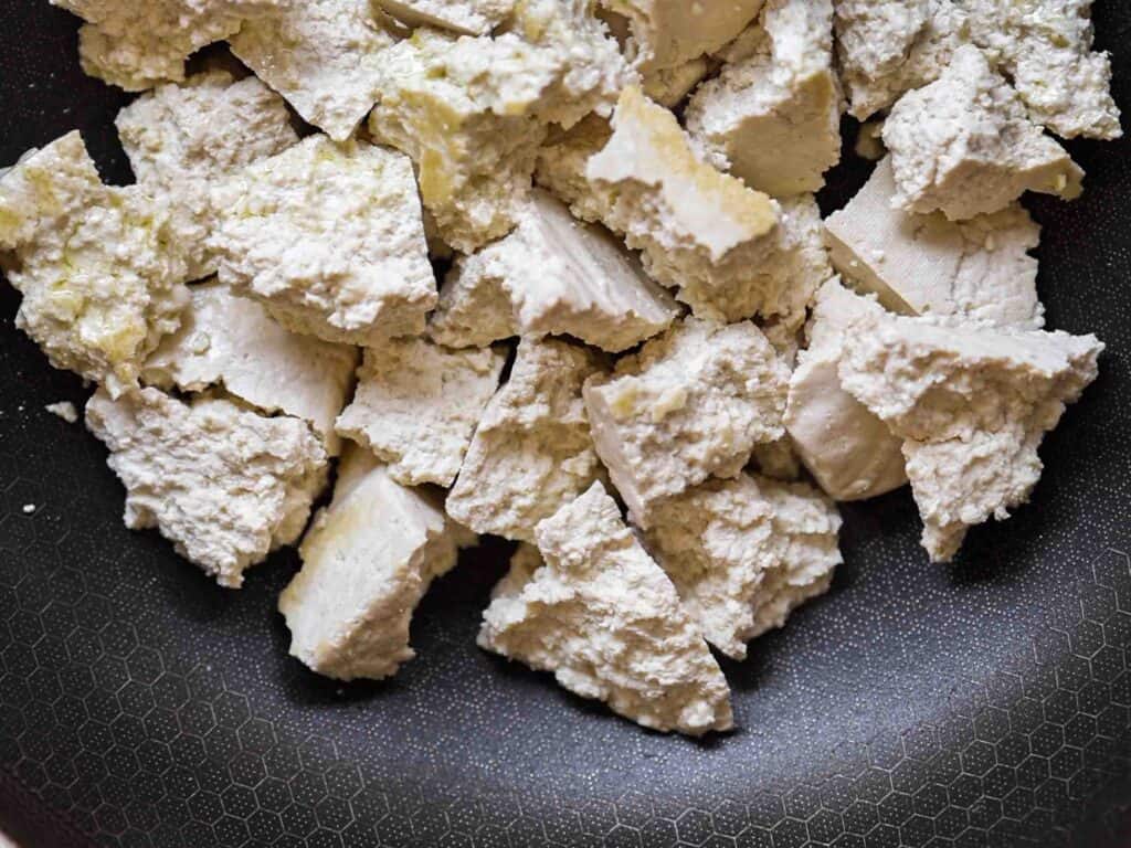 Hi-Protein Delicious Vegan Pumpkin Curry with Tofu. 7 close up shot of browning tofu in pan