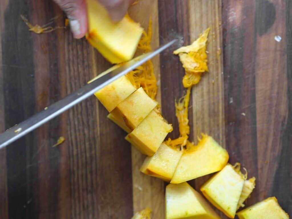 Hi-Protein Delicious Vegan Pumpkin Curry with Tofu. 14 chopping up fresh pumpkin into cubes