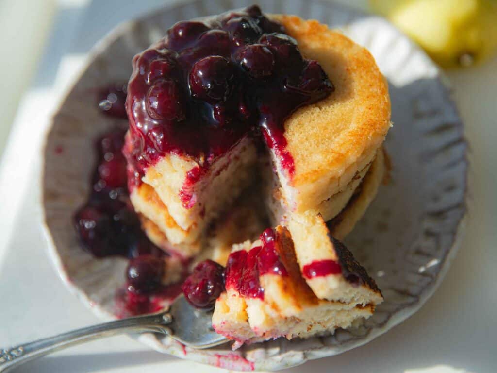 30-Minute Fluffy and Delicious Vegan Lemon Ricotta Pancakes. 29 top down view of vegan lemon ricotta pancakes with blueberry sauce