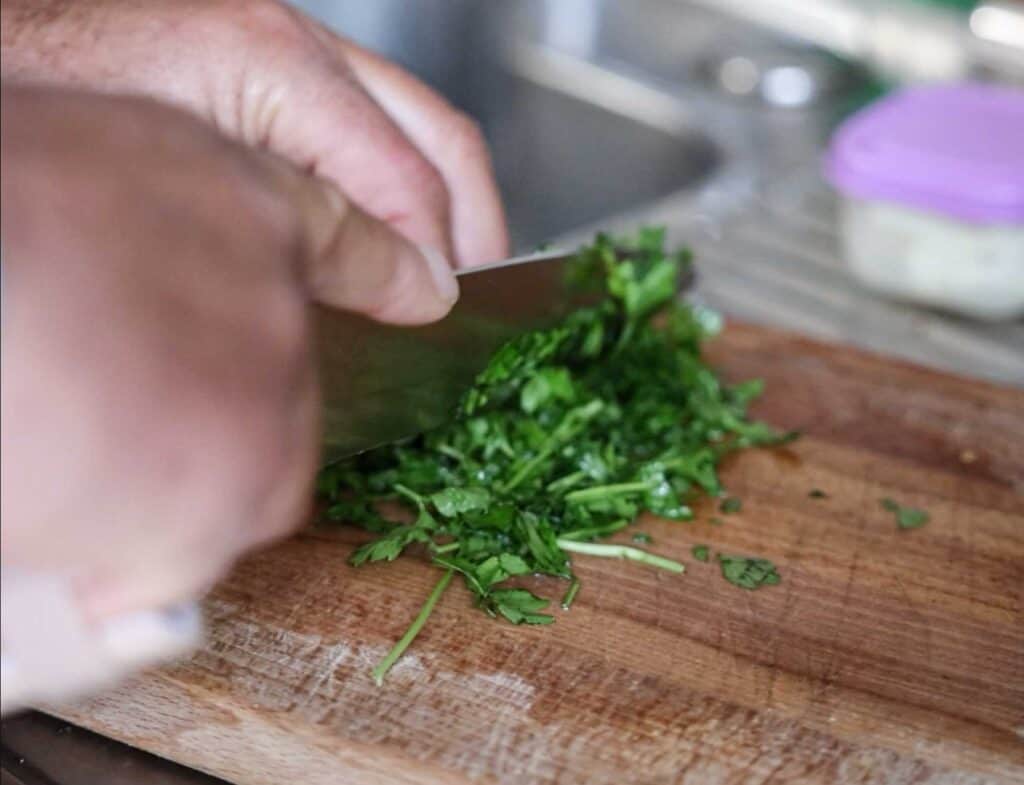 Spaghetti Aglio e Olio: The PERFECT 6-Ingredient Pasta Recipe. 8 chopping up flat leaf parsley