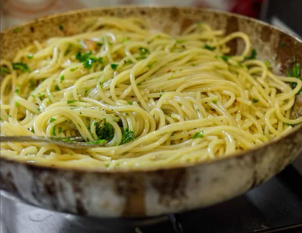 Spaghetti Aglio e Olio: The PERFECT 6-Ingredient Pasta Recipe. 3 a pan of completed aglio e olio