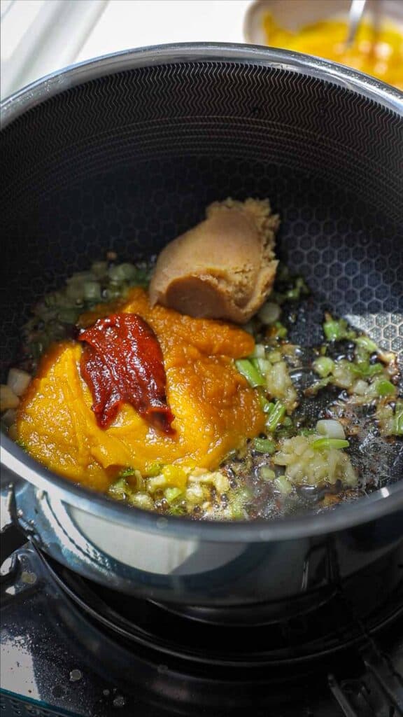 Easy Creamy and Spicy Pumpkin Ramen Recipe (Vegan). 17 miso pumpkin puree and gochujang in pot