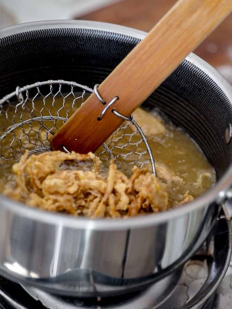 The BEST Green Beans with French Fried Shallots and Toasted Almonds. 9 scooping out french fried shallots