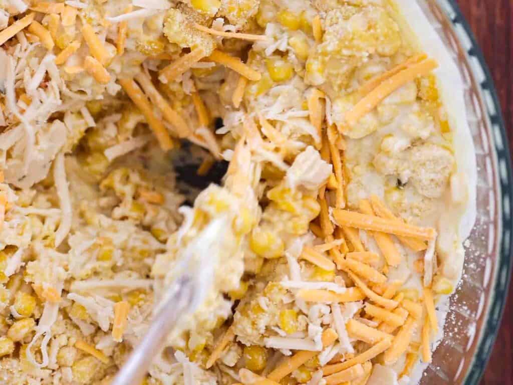 Easy and Delicious Cheesy Corn Soufflé (Dairy-Free and Gluten-Free Options). 12 mixing together corn souffle filling