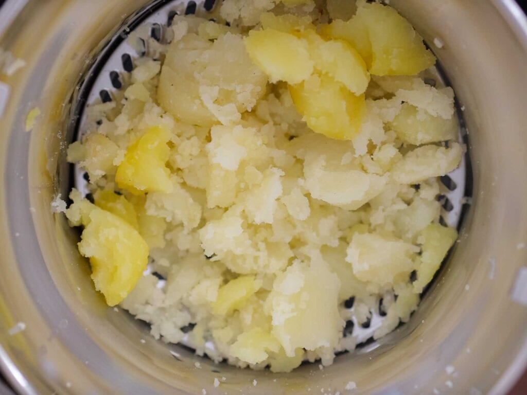 Tips on Making the BEST Creamy Mashed Potatoes (Dairy Free Option)! 6 another shot of potatoes in food mill