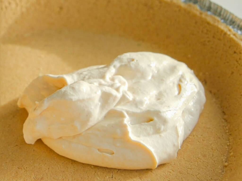 6-Ingredient BEST No-Bake Pumpkin Cheesecake (Vegan). 8 adding filling to graham cracker crust
