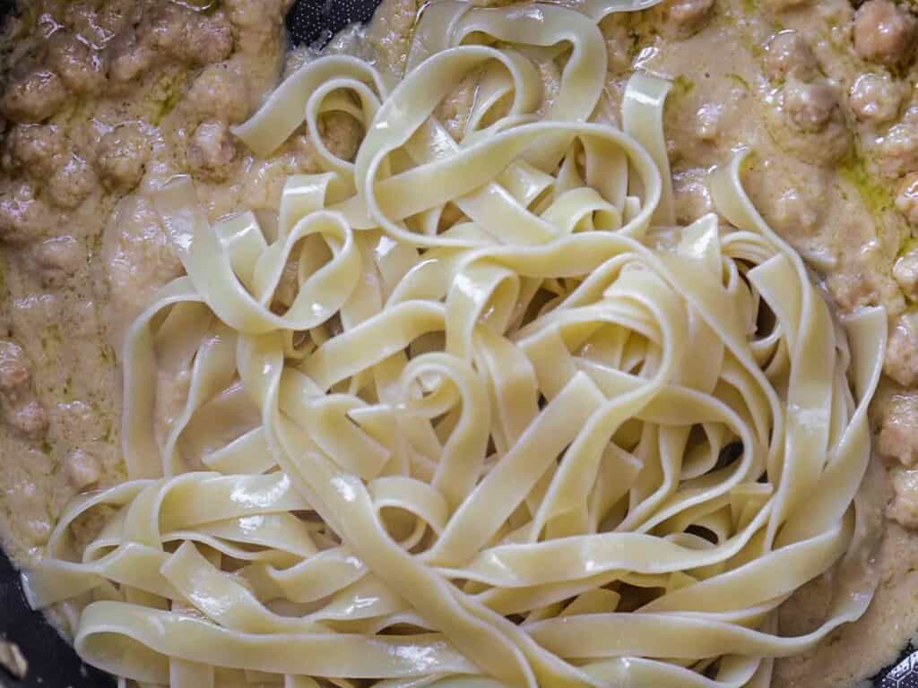 5-Ingredient Easy Chickpea Pasta Recipe (Pasta e Ceci). 15 Close-up of fettuccine pasta with a creamy sauce and chickpeas. The pasta is cooked and coated evenly with the sauce, creating a rich and appetizing texture.