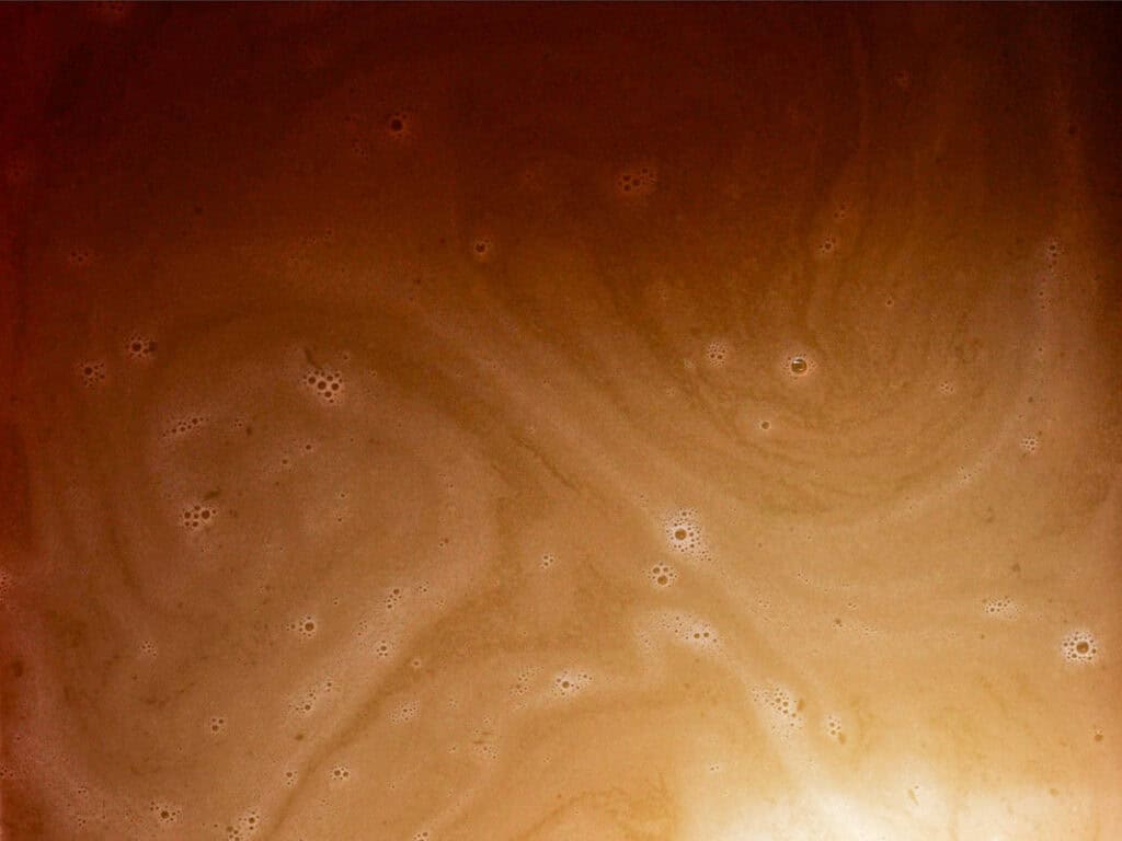 Mom's Easy White Kimchi (Baek-Kimchi) Recipe (백김치). 26 Swirling patterns of light and dark brown with small bubbles, resembling a foamy surface or liquid texture.