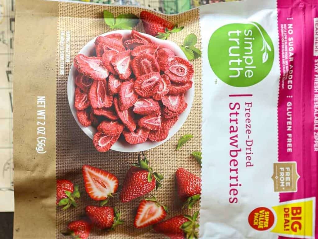 Stunning Pink Vegan Strawberry Cake (Fresh berries). 5 A package of Simple Truth Freeze-Dried Strawberries. The front displays a bowl filled with sliced strawberries, alongside whole strawberries on a burlap surface. The package is labeled as gluten-free and contains 2 ounces (56g).