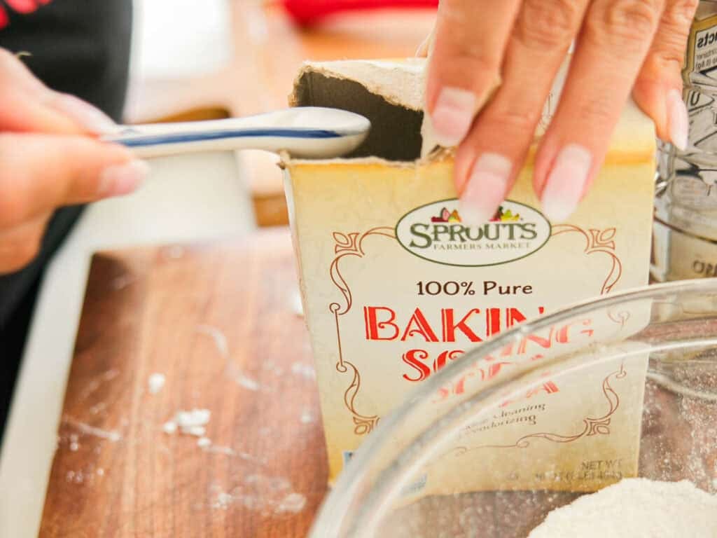 10 Tips for the Perfect Roasted Potatoes Recipe. 12 A person scoops baking soda from a Sprouts Farmers Market box with a measuring spoon over a mixing bowl on a wooden surface.