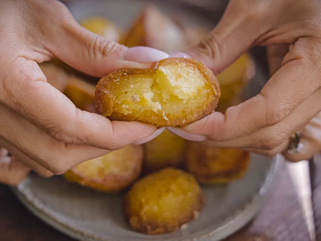 10 Tips for the Perfect Roasted Potatoes Recipe. 22 two hands holding a roasted potato and squeezing it