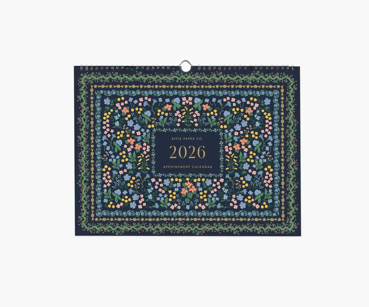 The Korean Vegan's 2025 VEGAN Holiday Gift GUIDE. 25 A 2026 appointment calendar with a navy blue cover, featuring colorful floral patterns and a central box that reads Rifle Paper Co. 2026 Appointment Calendar—perfect as a vegan holiday gift for anyone on your gift guide.