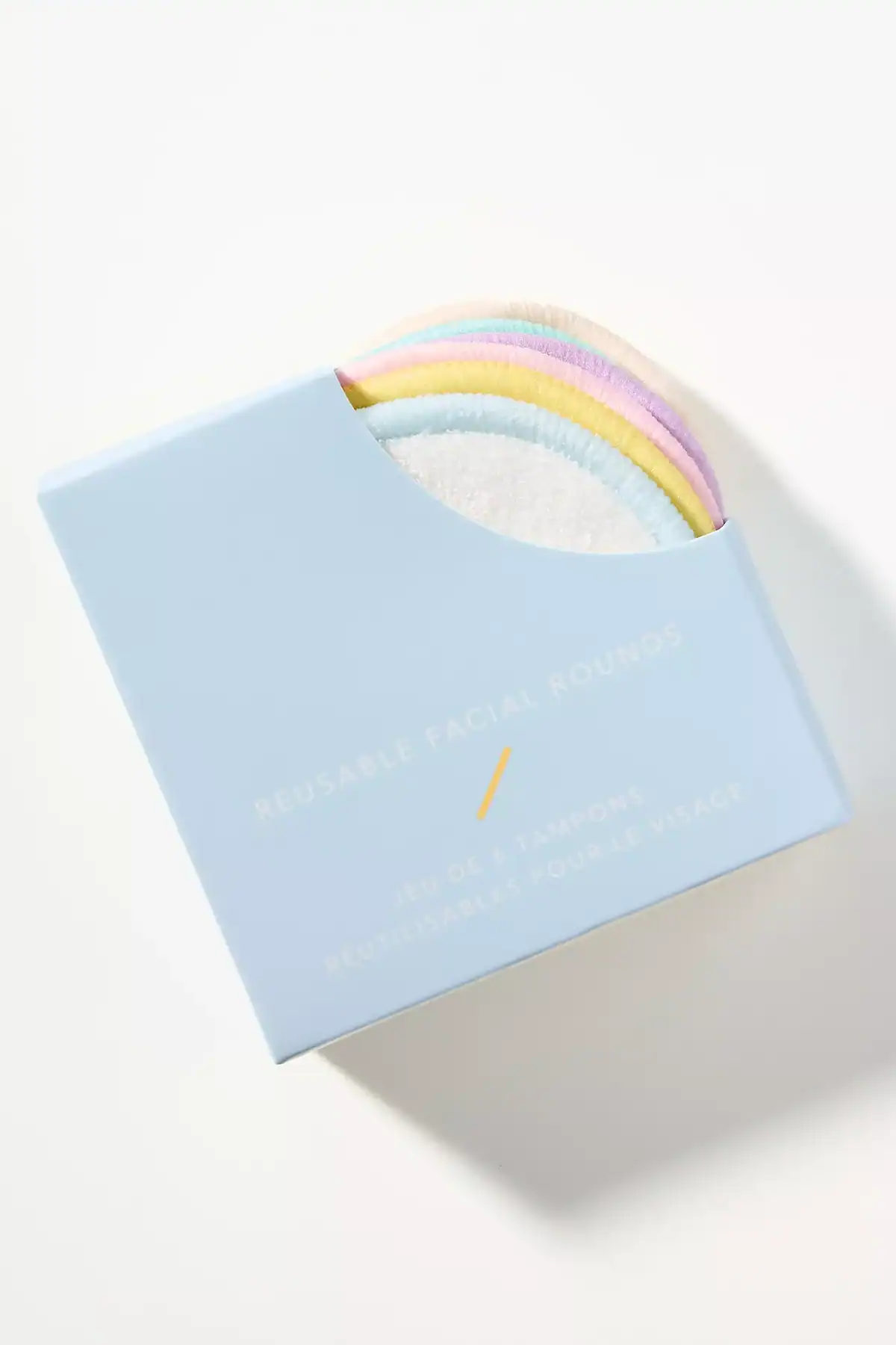 The Korean Vegan's 2025 VEGAN Holiday Gift GUIDE. 31 A light blue box labeled Reusable Facial Rounds holds several soft, round facial pads in pastel colors, partially visible at the top of the open packaging—an ideal Vegan Holiday Gift featured in our 2025 Gift Guide.