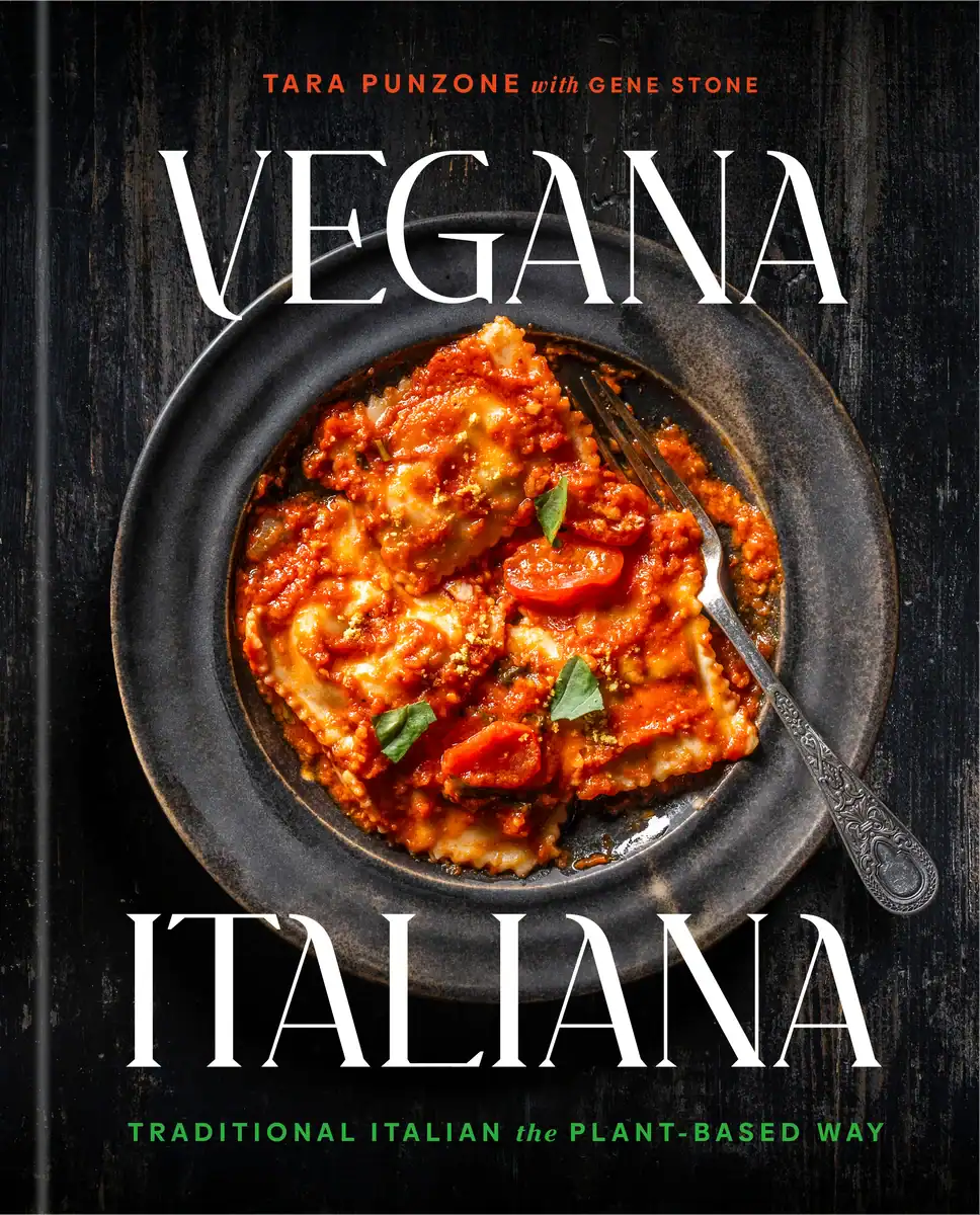 The Korean Vegan's 2025 VEGAN Holiday Gift GUIDE. 4 Cover of the cookbook Vegana Italiana, featuring a plate of ravioli topped with tomato sauce and basil on a dark wooden surface. Perfect for any VEGAN Gift Guide or as a Vegan Holiday Gift, showcasing plant-based Italian cooking by the authors.