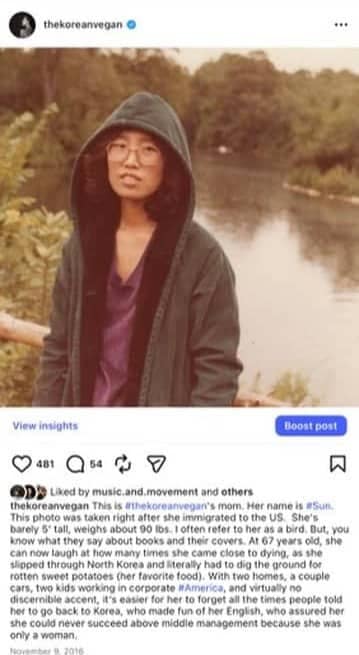 That time I met Barack Obama. 2 A woman wearing glasses and a hooded jacket stands outdoors near a body of water, with greenery in the background. She faces the camera with a neutral expression, reminiscent of old photographs featuring figures like Barack Obama in candid moments.