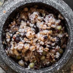 Gut Healthy Korean Multigrain Rice - Japgokbap (잡곡밥) 19 A close-up of Korean multigrain rice, or Japgokbap, featuring gut healthy cooked grains and beans in a stone bowl. The mix appears slightly sticky with an appealing blend of light and dark colors.